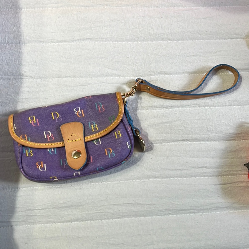 Dooney and Bourke wristlet/leather, few color imperfections.